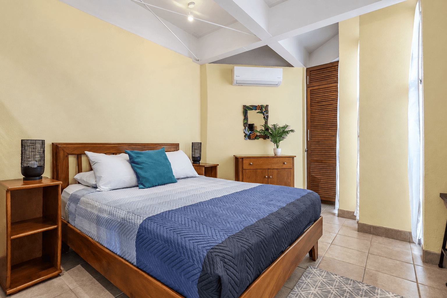 Primary queen bedroom at Tucanes 12 vacation rental in Playas del Coco