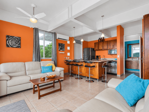 Open living area and kitchen at Tucanes 12 vacation rental in Playas del Coco